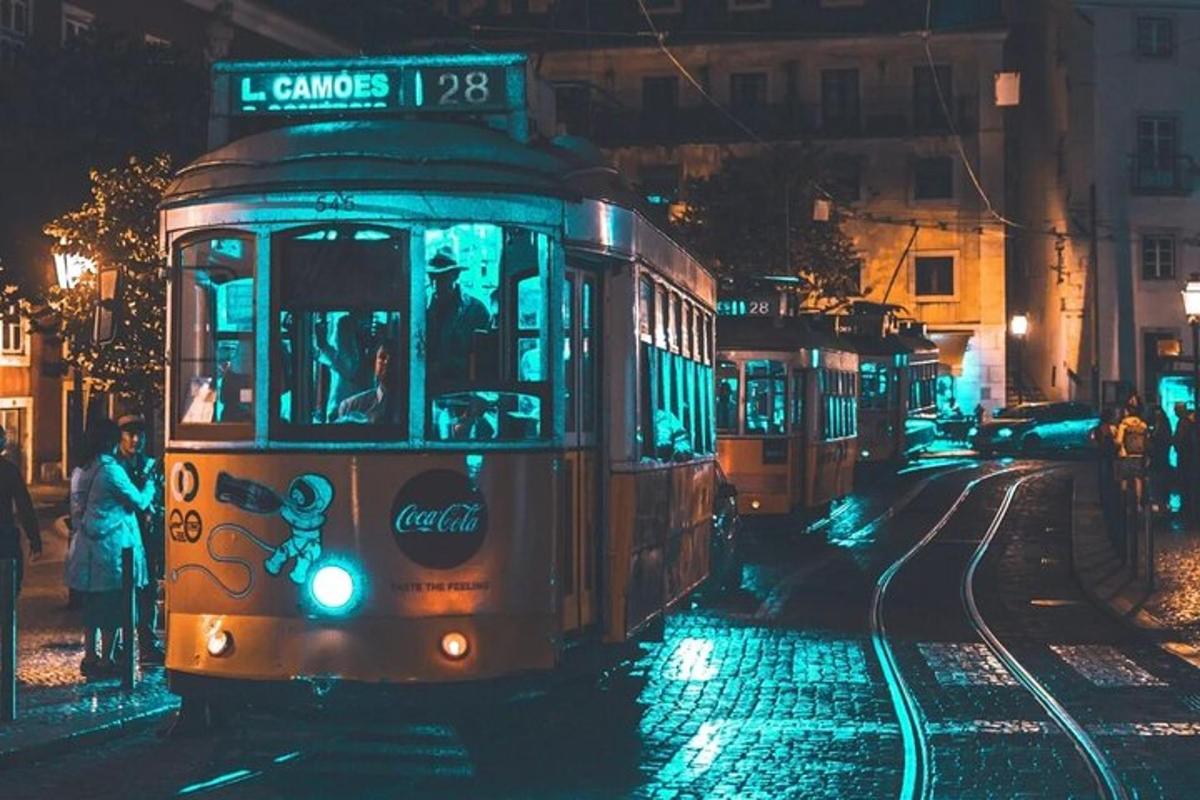 a trolley car driving down a street at night
