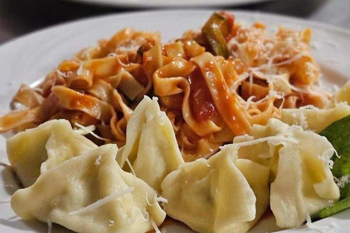 a plate of ravioli with cheese and sauce