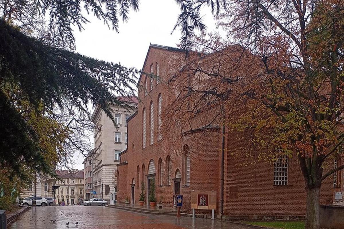 a brick building on a street in the rain
