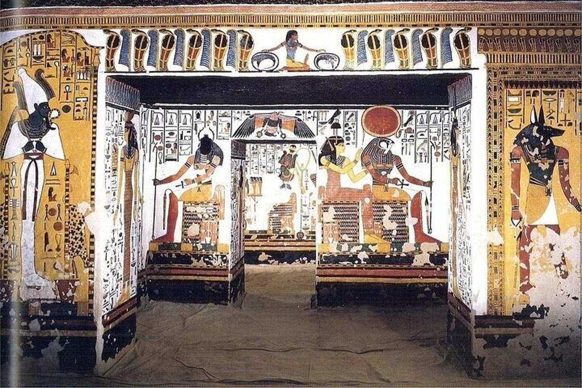 an entrance to a building with paintings on the wall