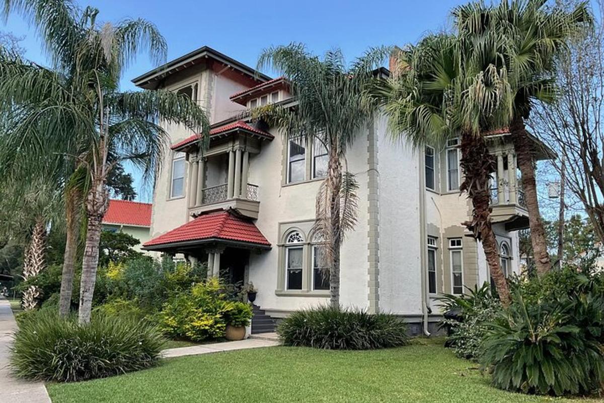 a large house with palm trees in front of it