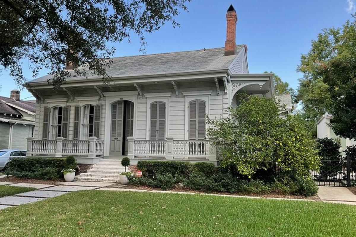 a white house with a porch and a chimney