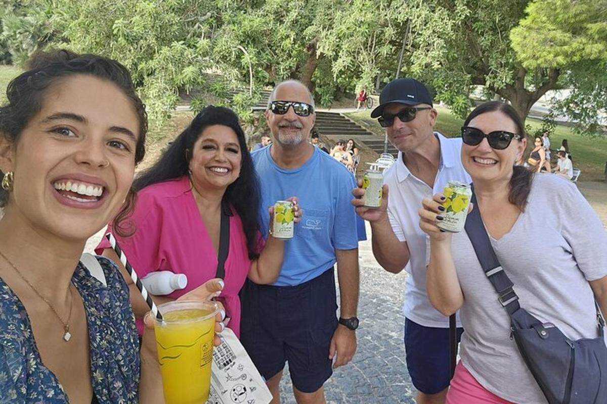 a group of people posing for a picture with drinks