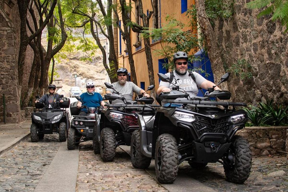 a group of people riding atvs down a street