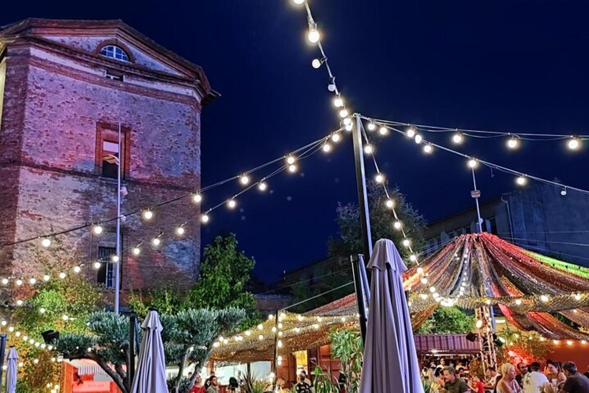 a christmas market with lights and a building