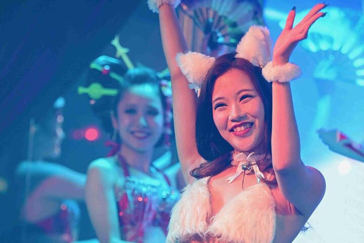 a woman in a costume with her arms in the air