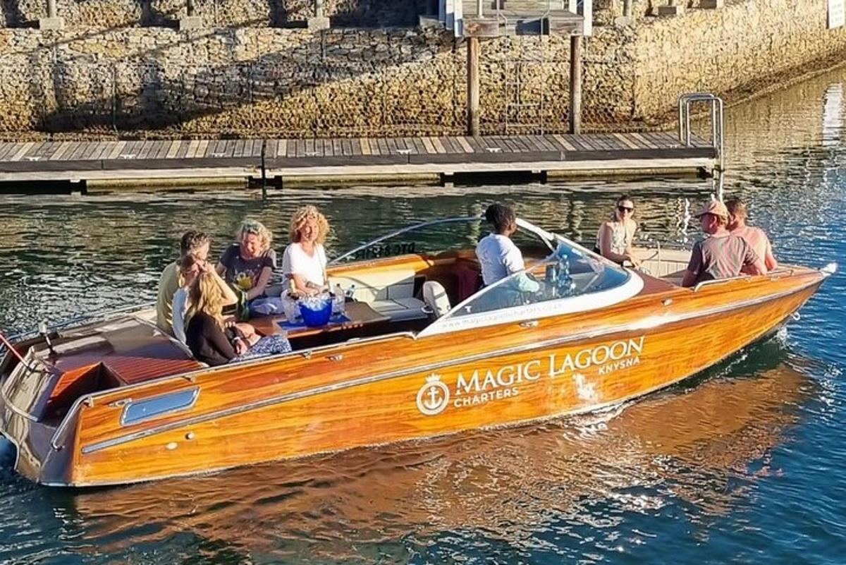 a group of people in a wooden boat on the water