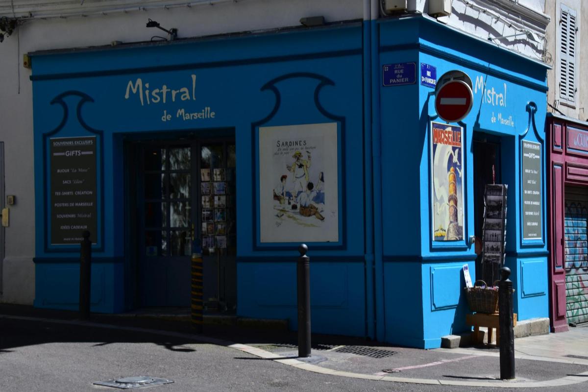 a blue building on the side of a street