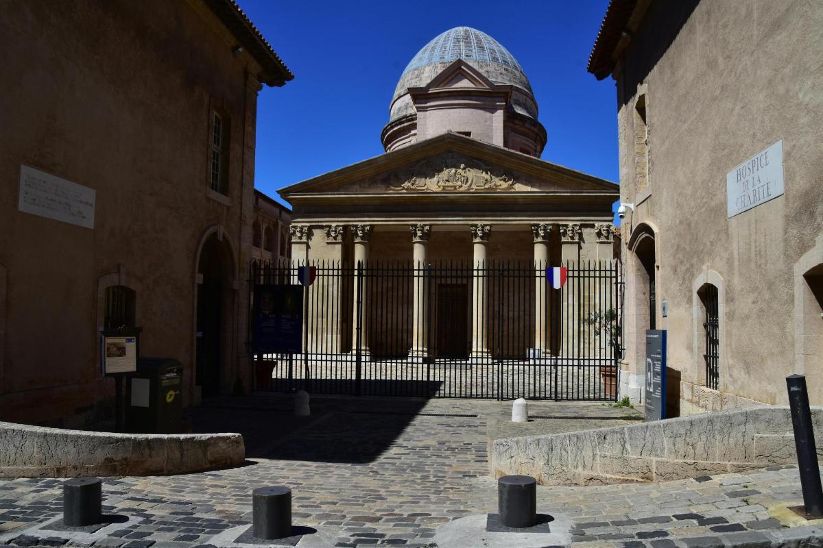 a building with a gate and a dome on top