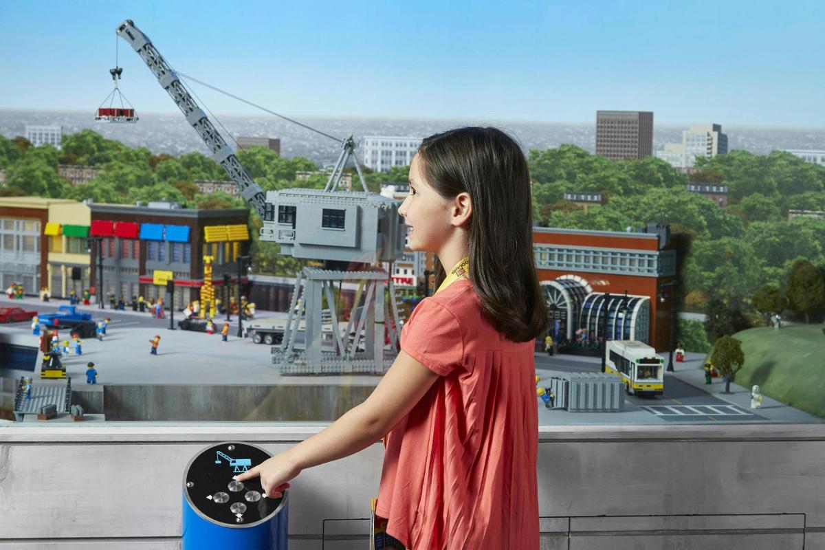 a young girl is looking at a play park
