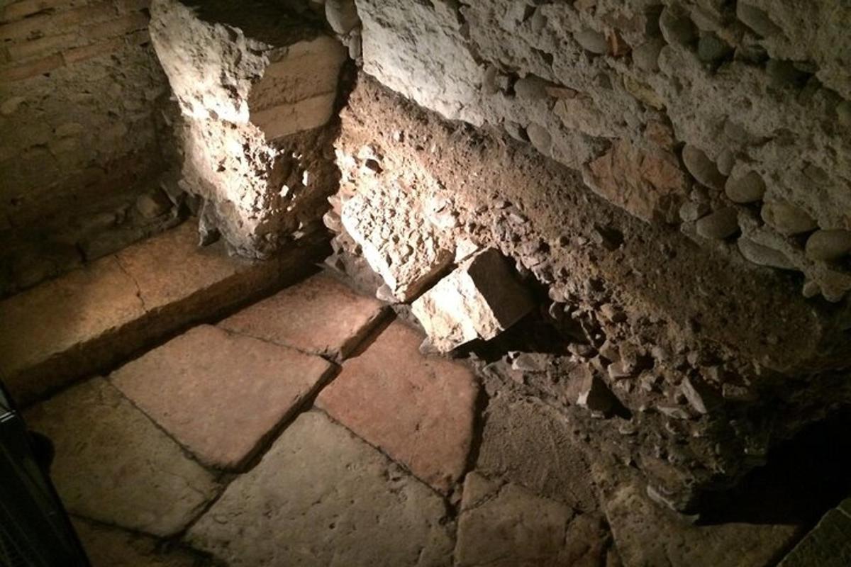 an old brick wall with a light shining on it