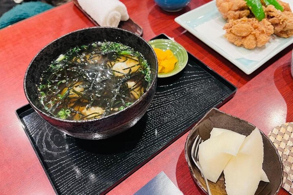 a bowl of soup and a plate of food on a table