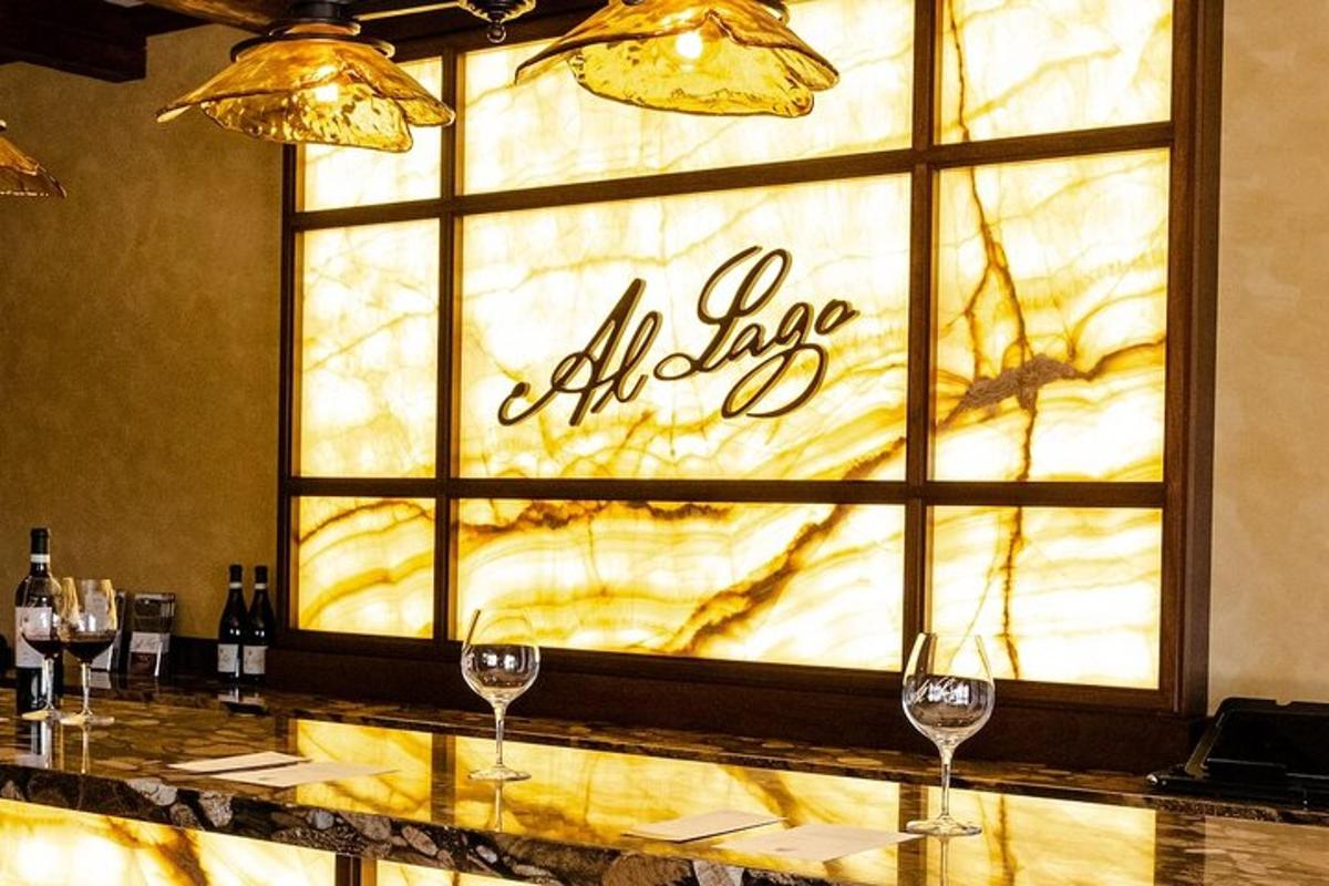 a bar with wine glasses in front of a window