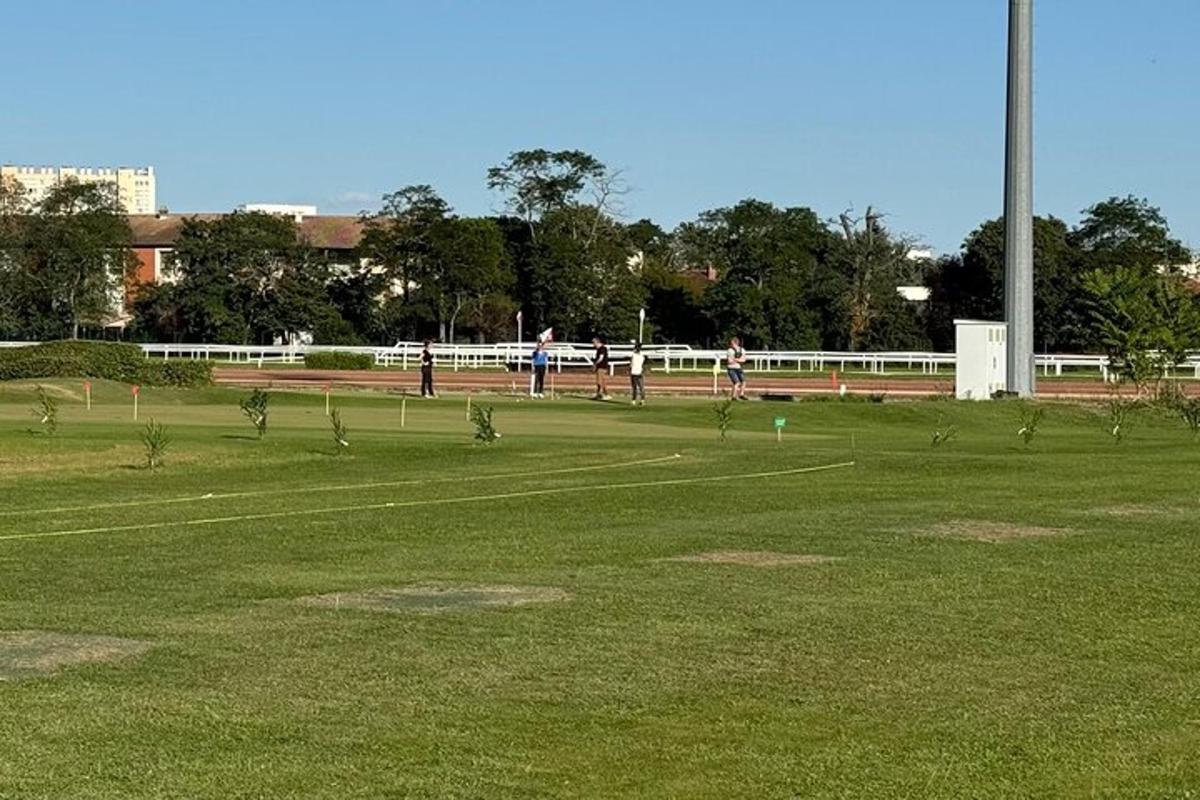a field with people playing a game of frisbee