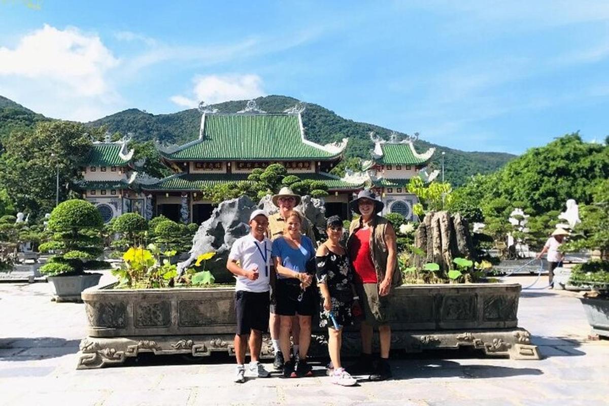a group of people standing in front of a fountain in front of a building