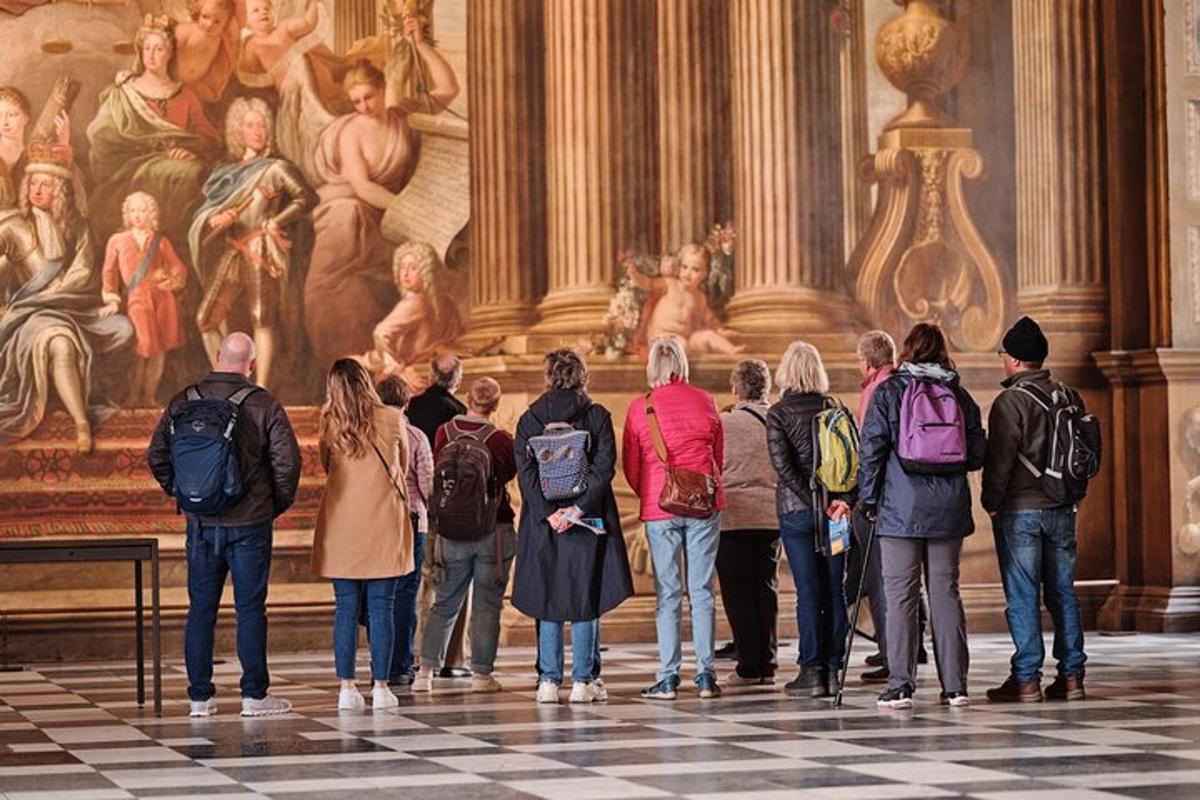 a group of people standing in front of a painting