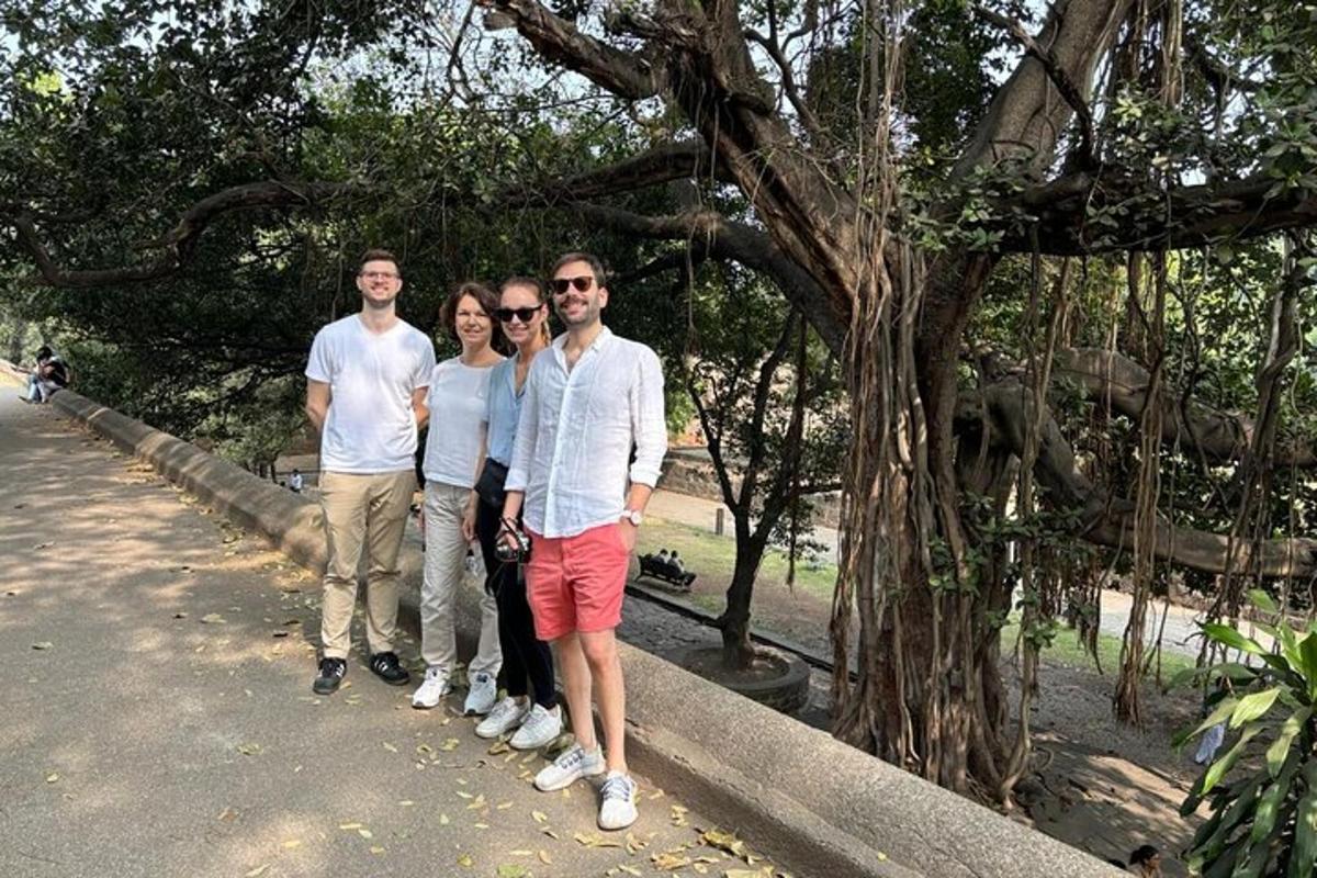 a group of people standing next to a tree
