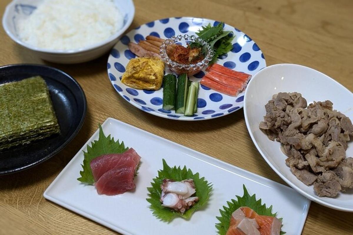 a table topped with plates of food and bowls of rice