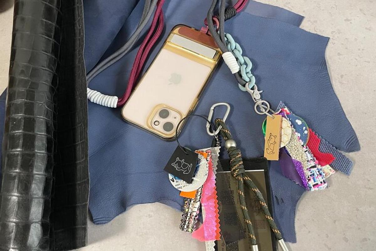 a cell phone on a chain with keys and tags