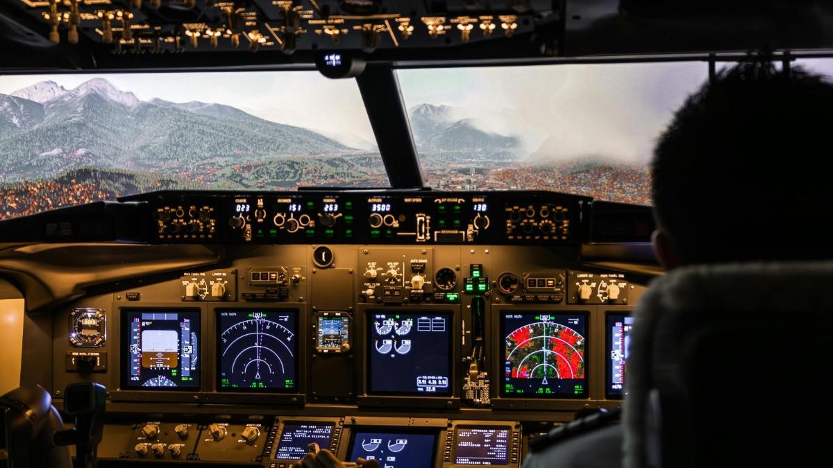 a person sitting in the cockpit of an airplane
