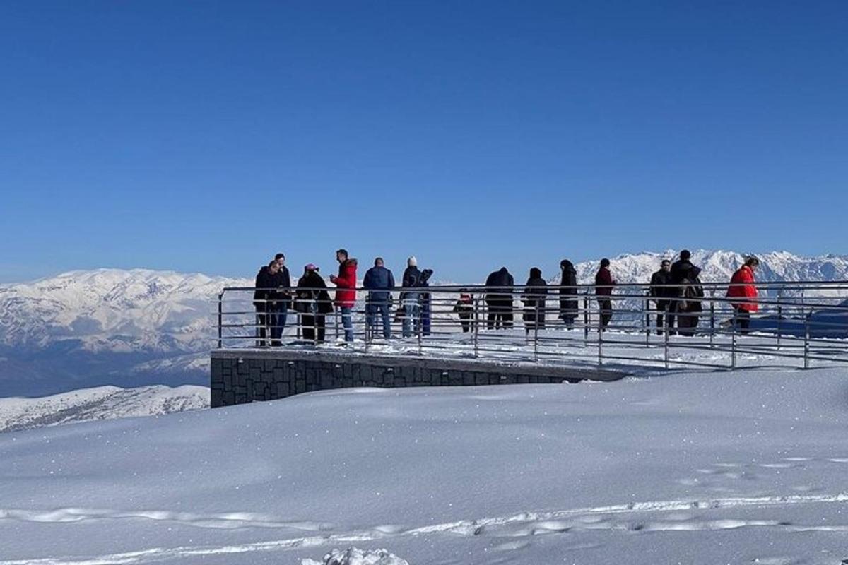 a group of people standing on a bridge in the snow