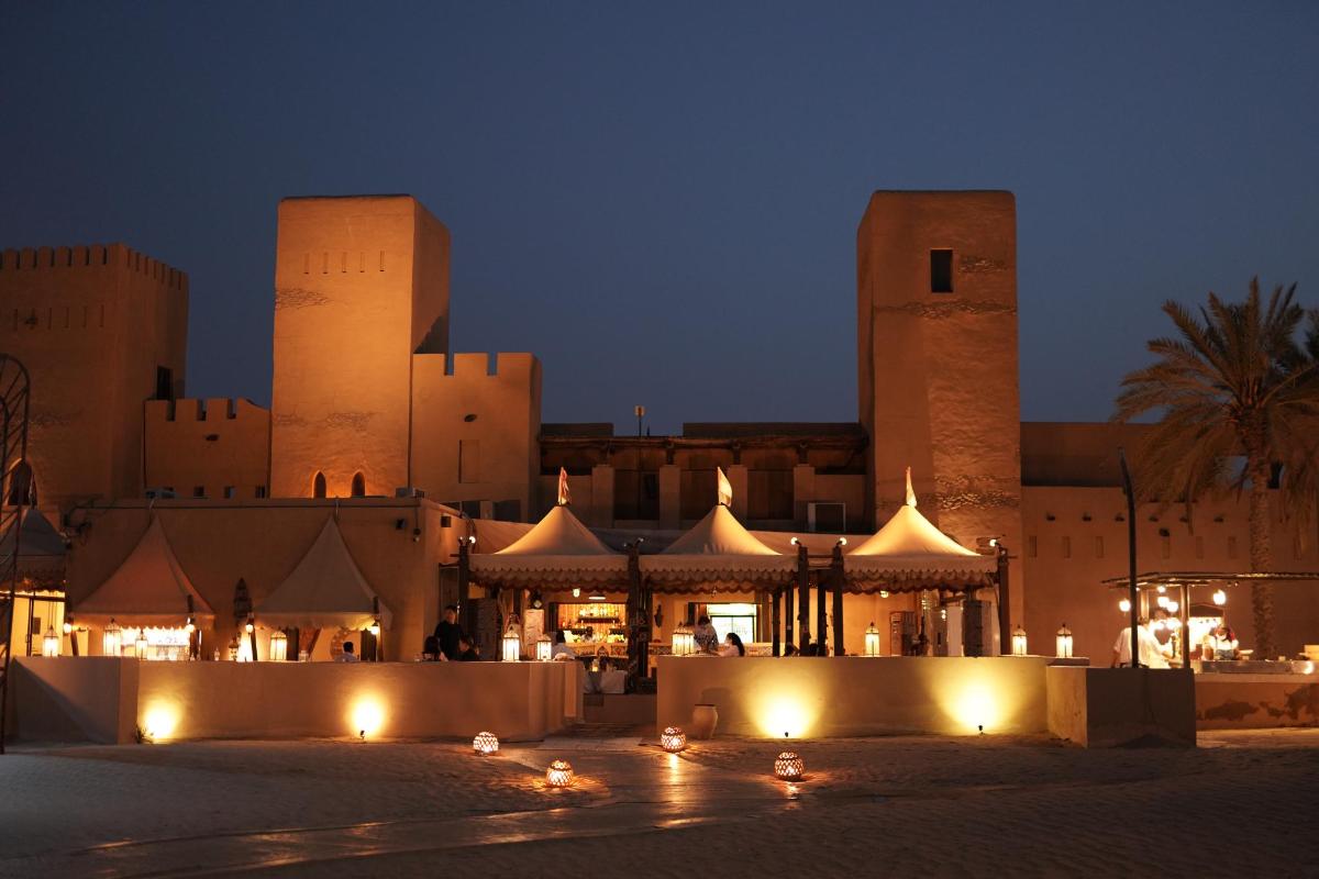 a large building with tall towers at night