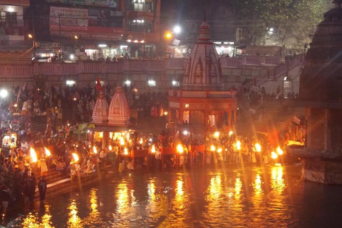 a crowd of people with lights in the water at night