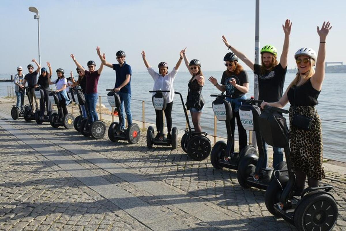 a group of people on segways on the beach