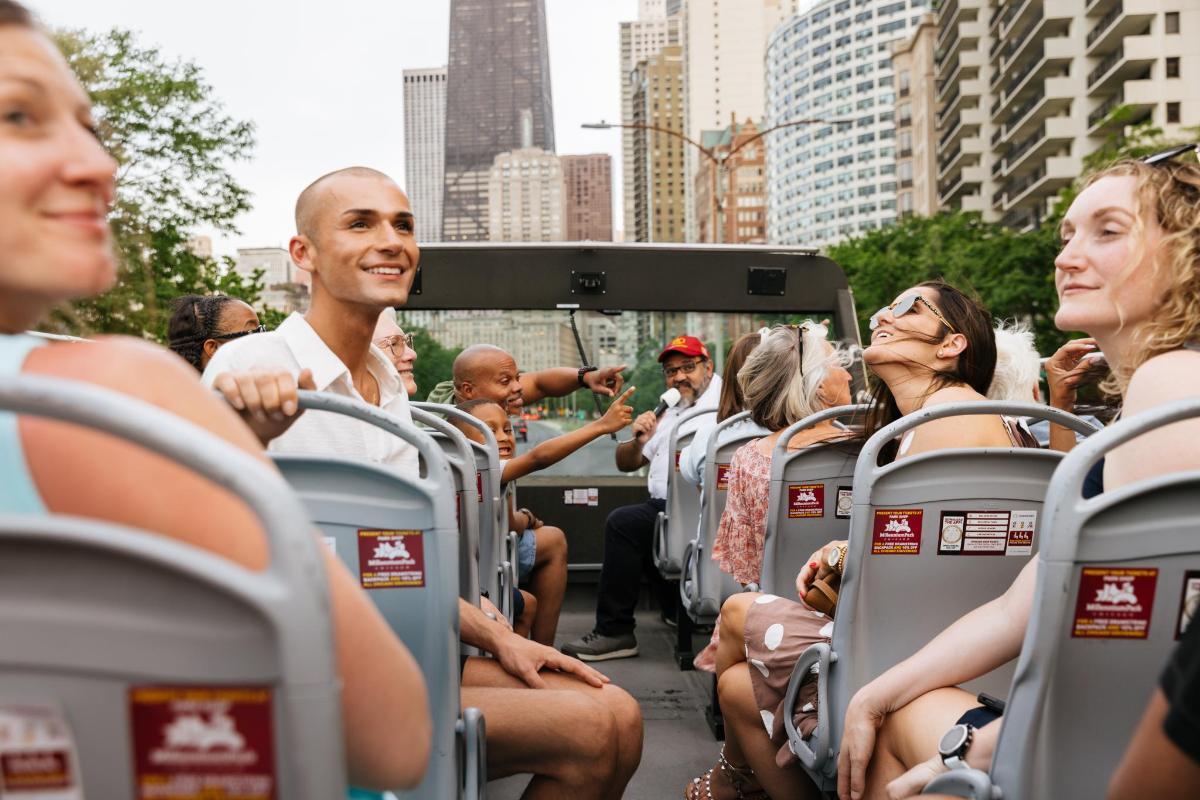 a group of people sitting in seats in a bus