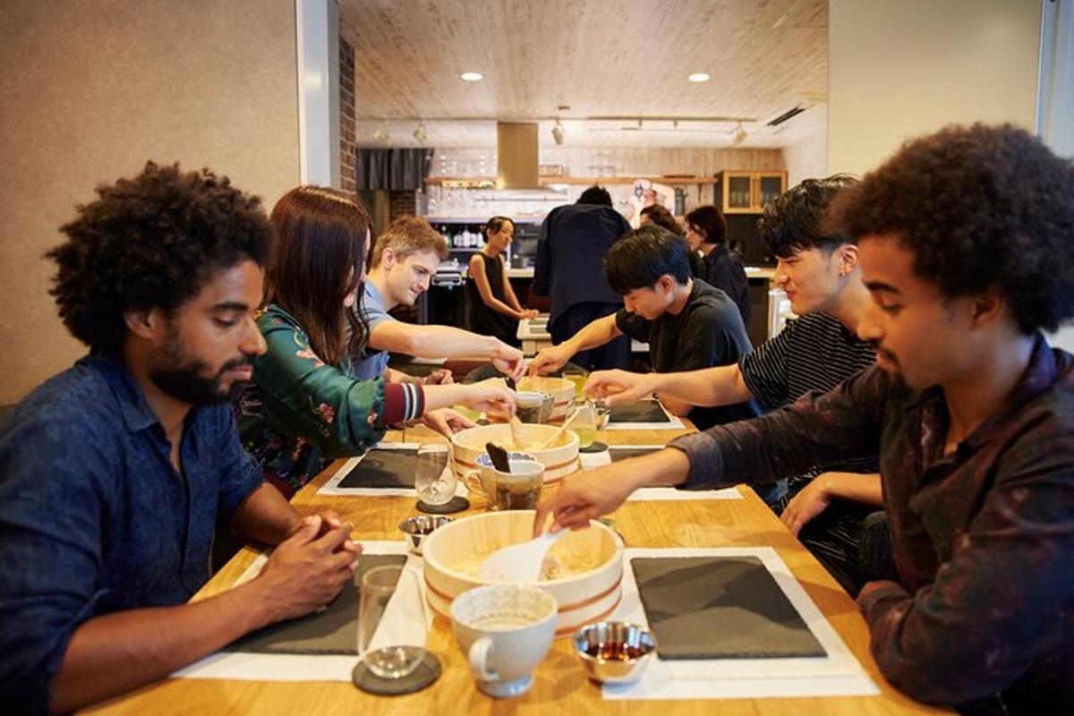 a group of people sitting at a table eating food