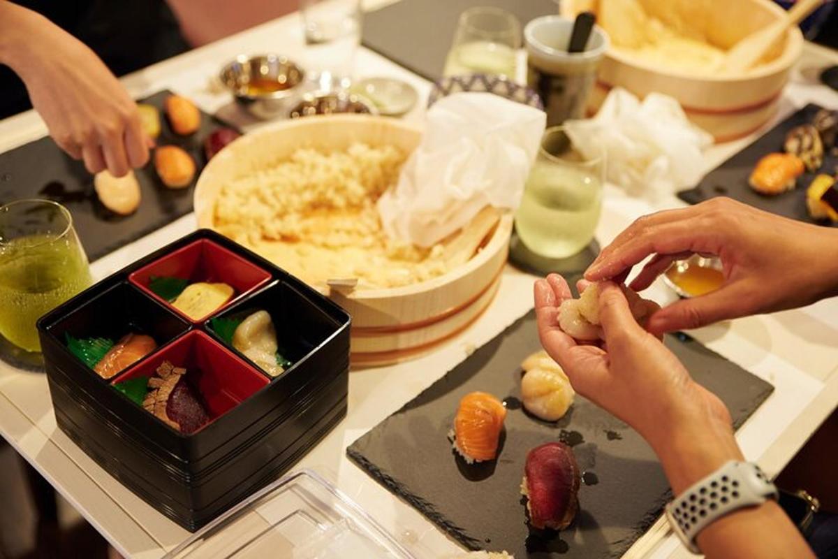a table topped with sushi and a tray of food