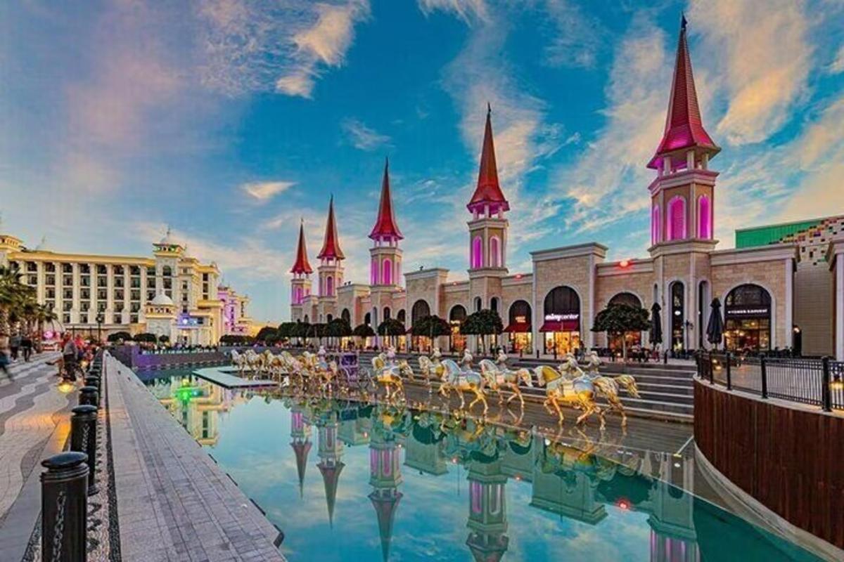 a view of the disney resort with its reflection in the water
