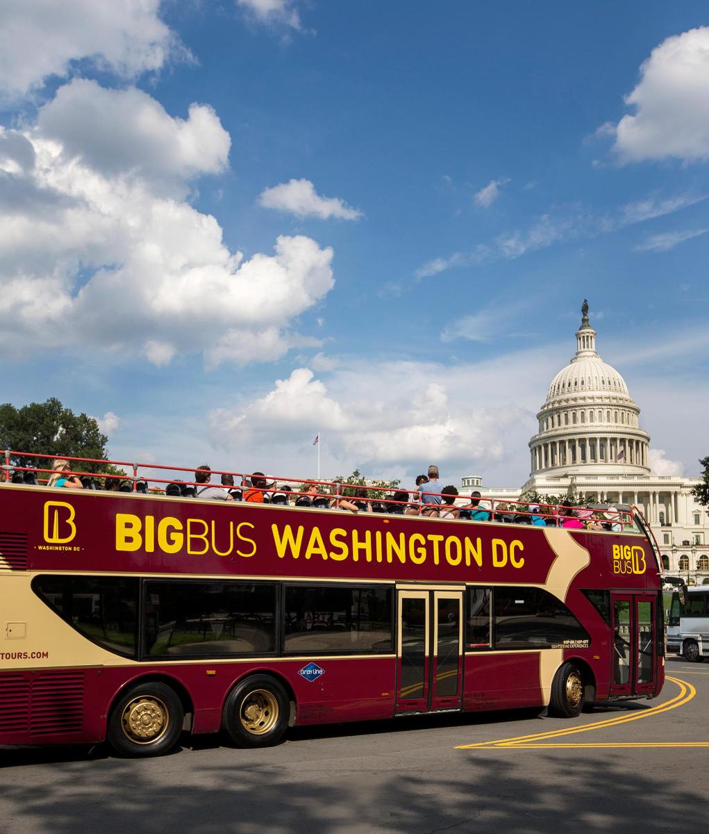 a double decker bus parked in front of the capitol building