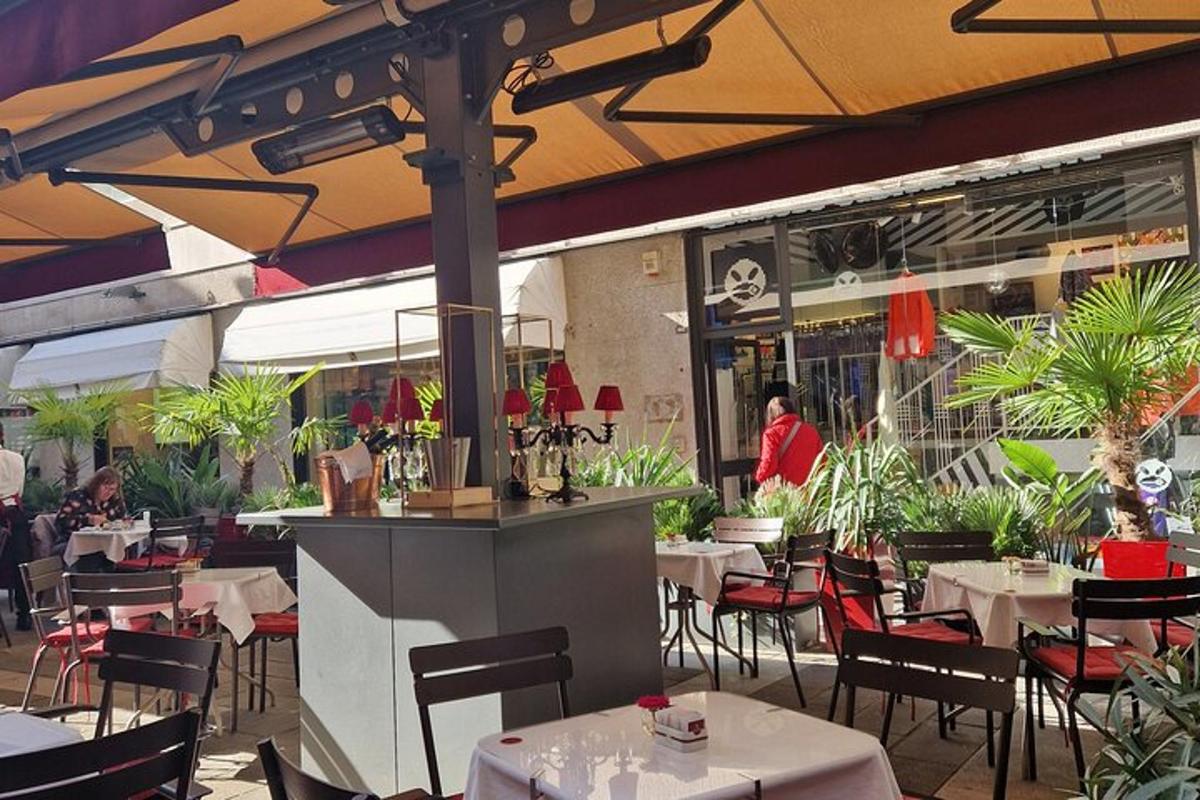 a restaurant with white tables and chairs and an umbrella