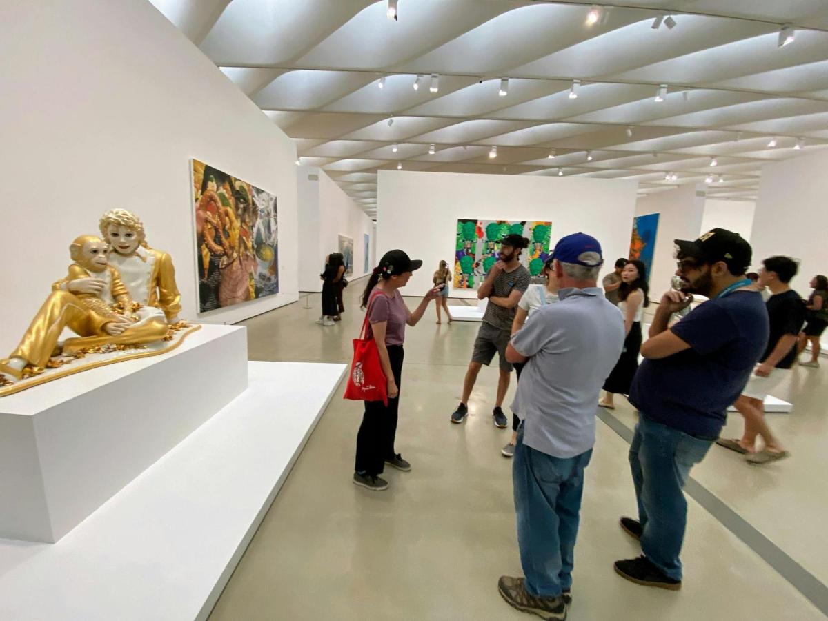 a group of people looking at art in a museum