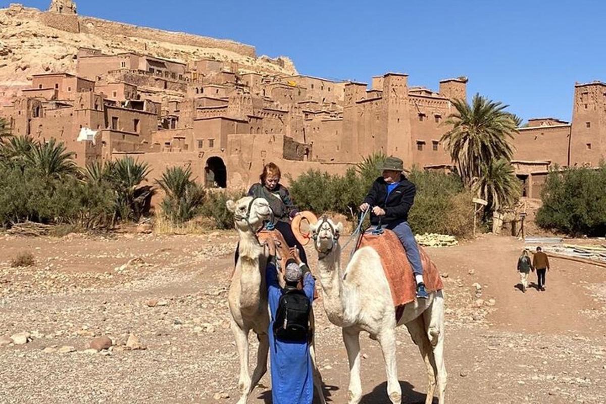 a group of people riding horses in front of a castle
