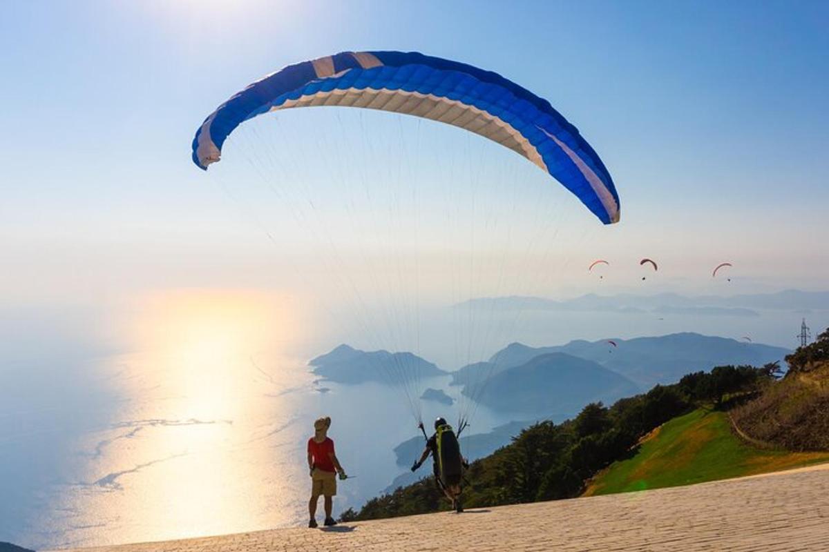 ένα άτομο που πετάει χαρταετό στην κορυφή μιας παραλίας