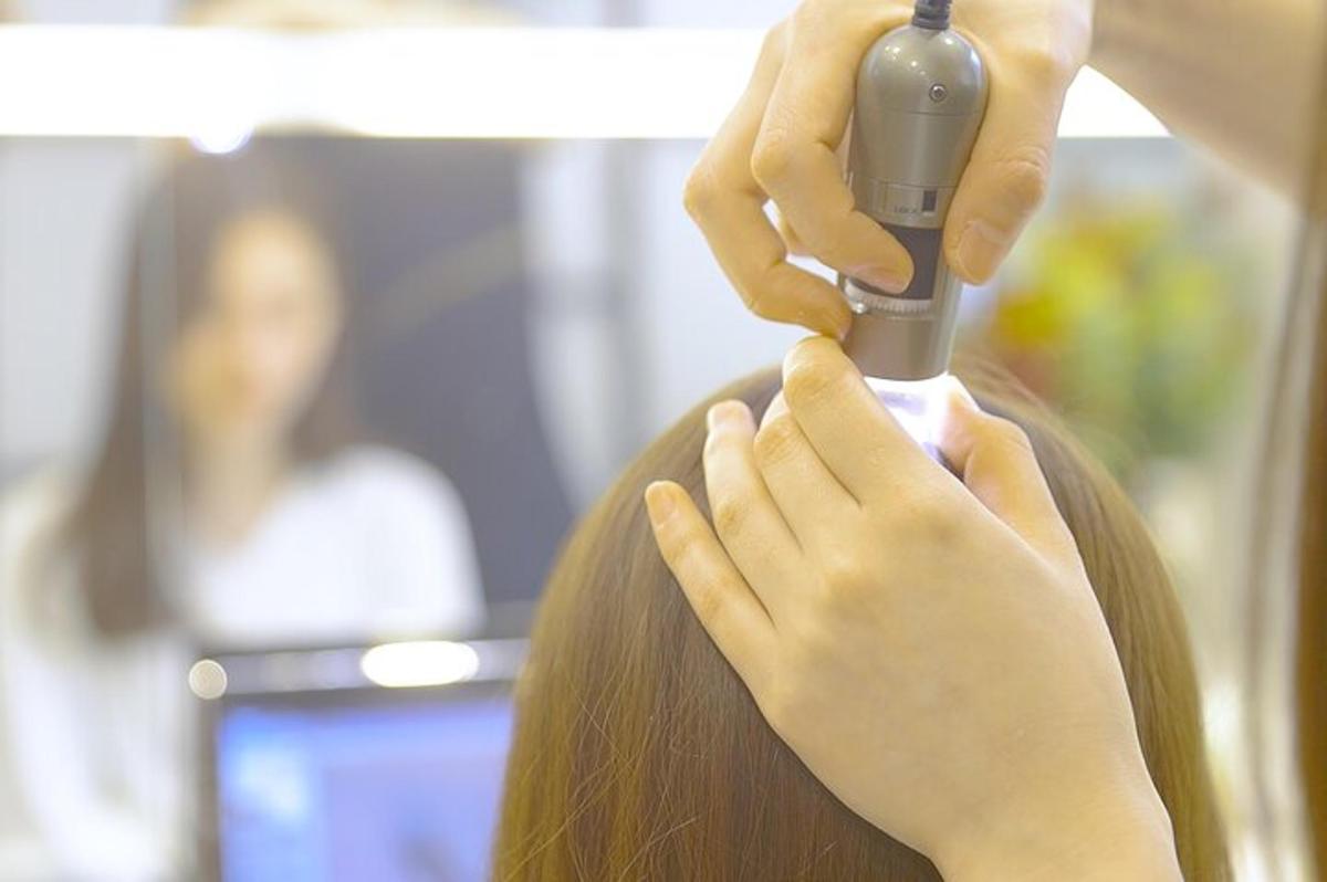 a woman getting her hair cut with a blow dryer