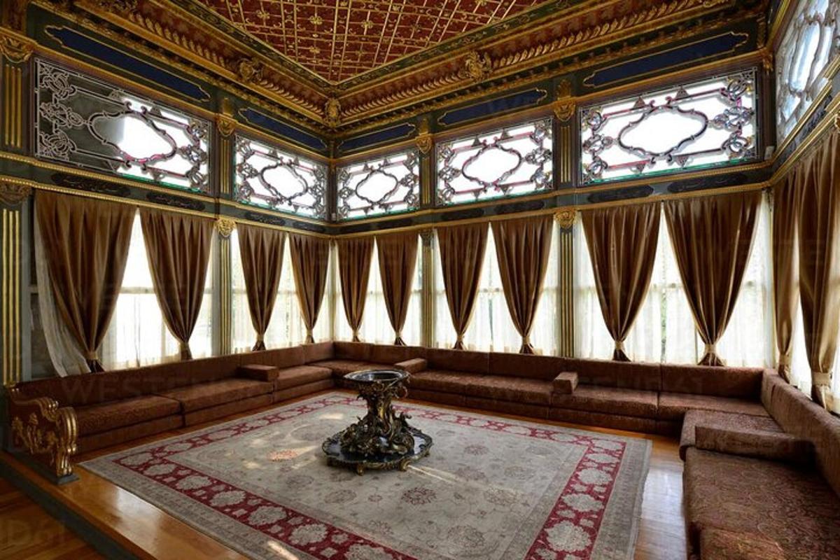 a large room with windows and a vase on a table
