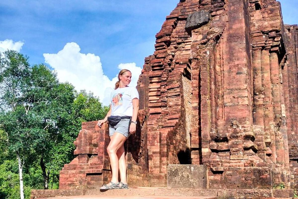 a woman is standing on the side of a building