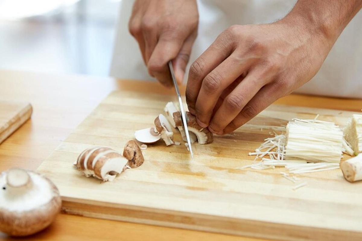 một người đang cắt nấm trên thớt