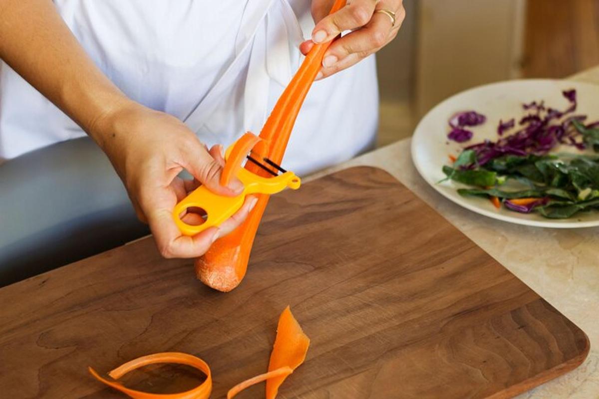 isang taong may hawak na karot sa isang cutting board