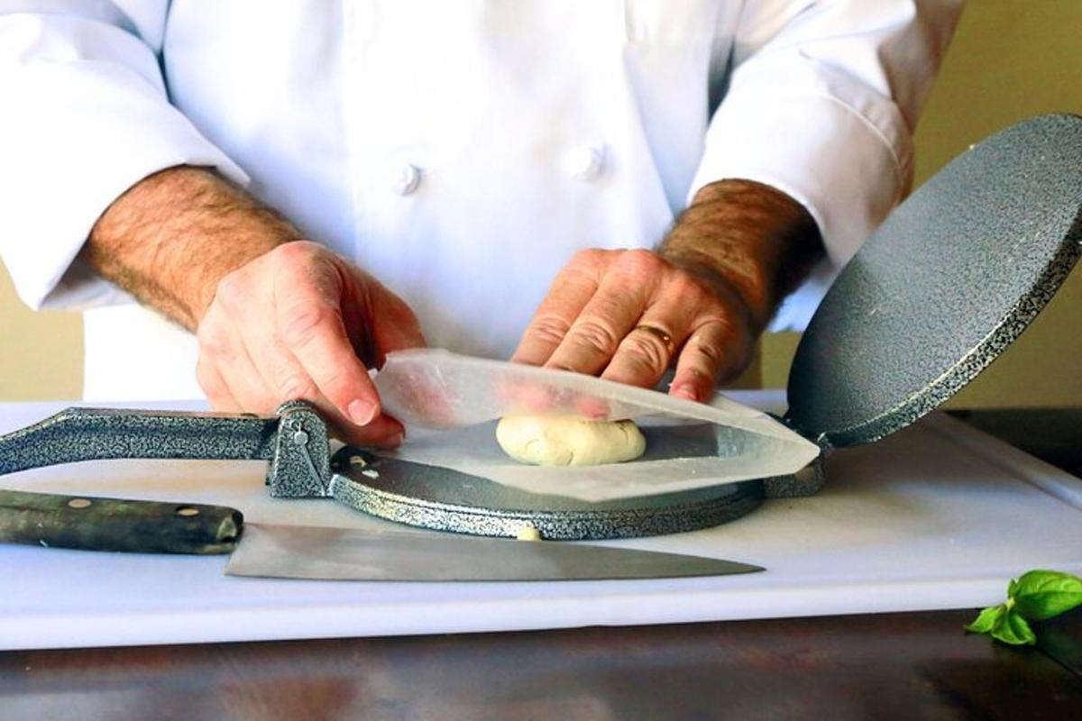 Un chef cortando una cebolla con un cuchillo en una tabla de cortar.