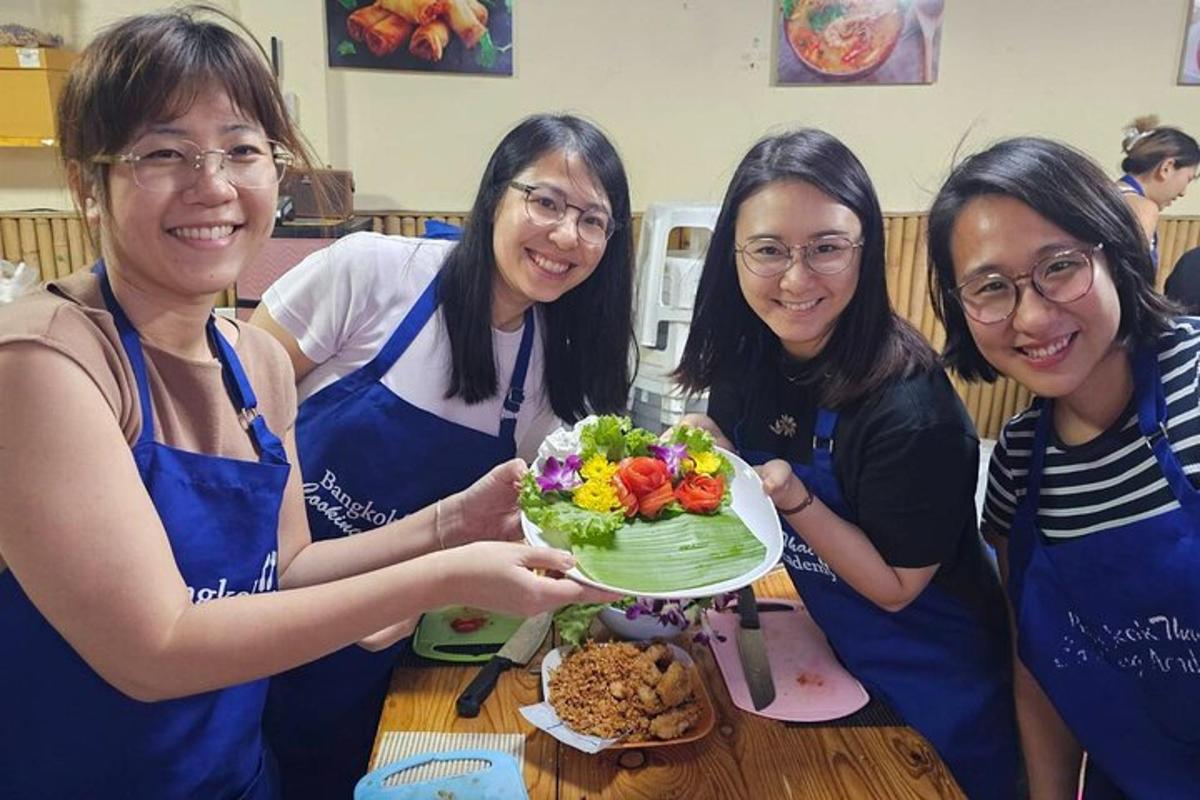 a group of women holding a cake on a table