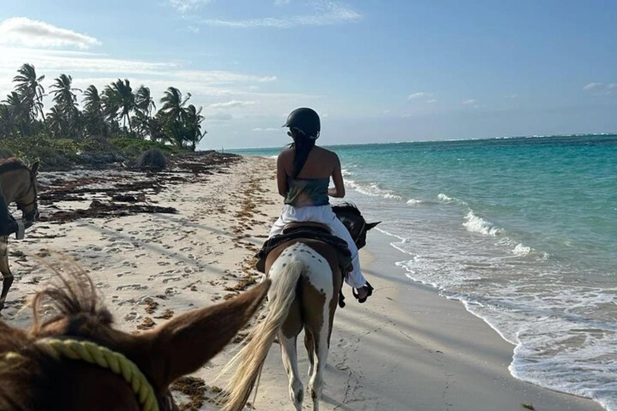 una donna a cavallo sulla spiaggia