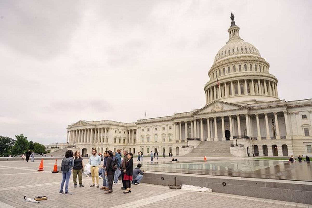 a group of people standing in front of the united states capitol building