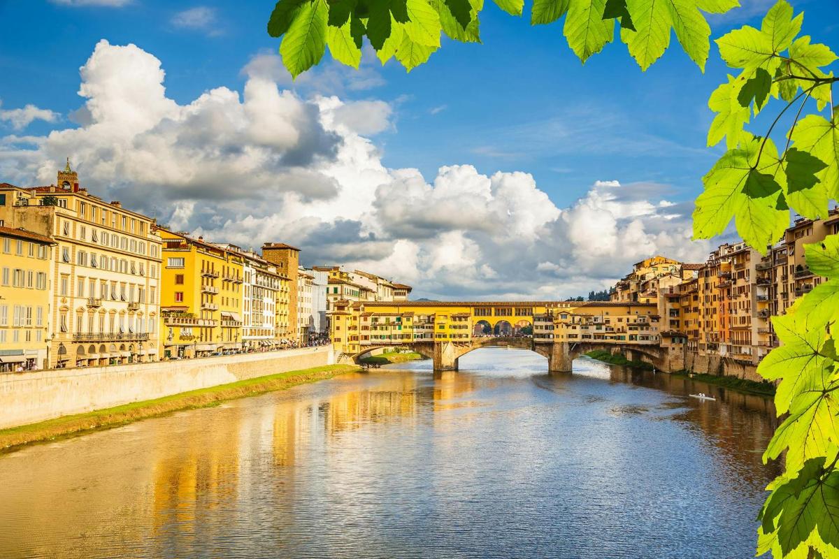 a bridge over a river in a city with buildings