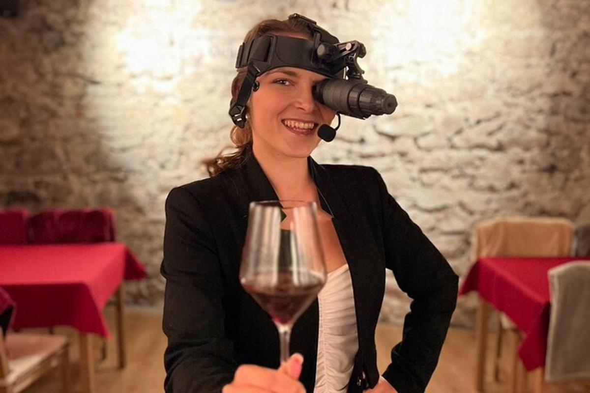 žena s brýlemi pro virtuální realitu držící sklenici vína