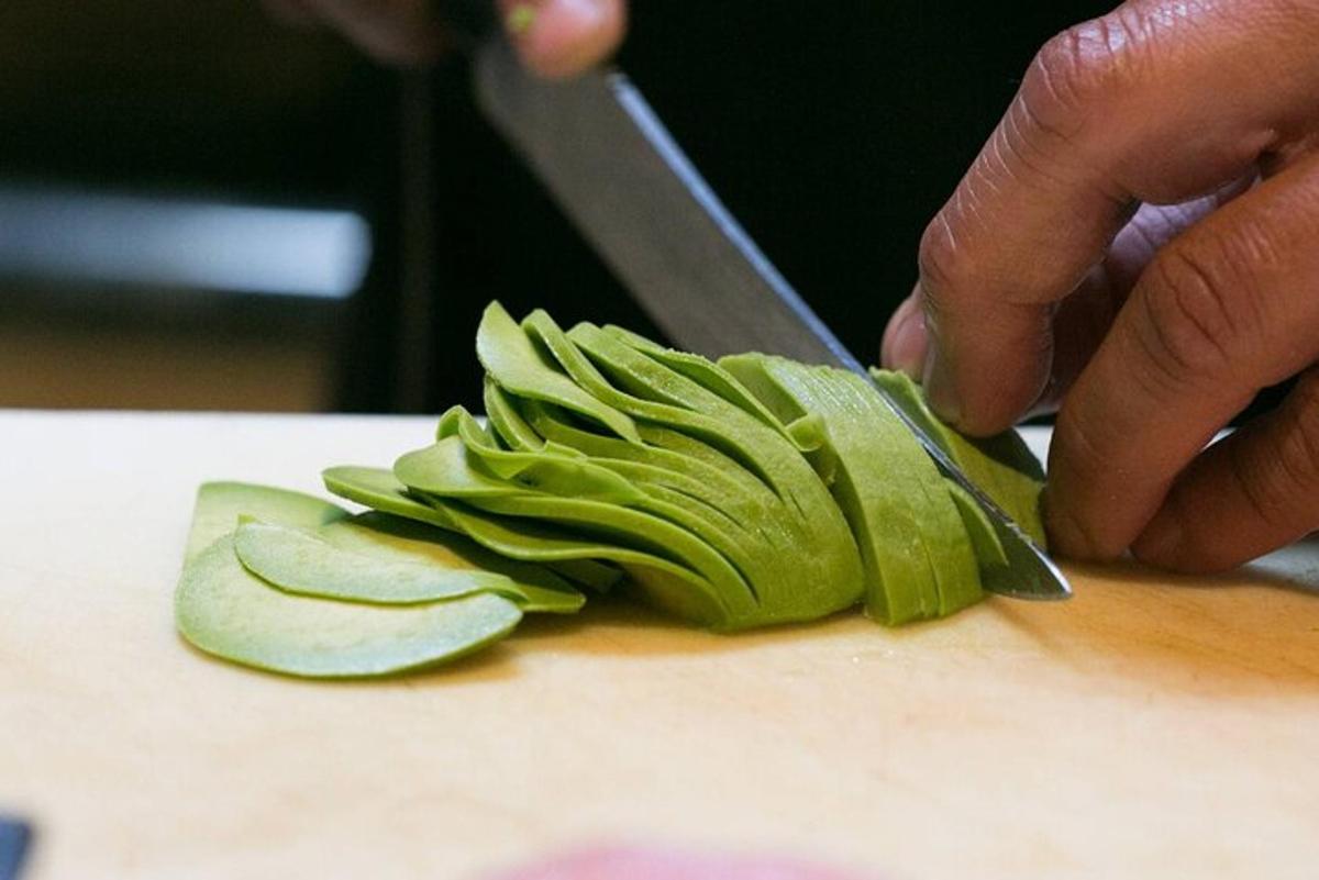 a person cutting up an apple on a cutting board
