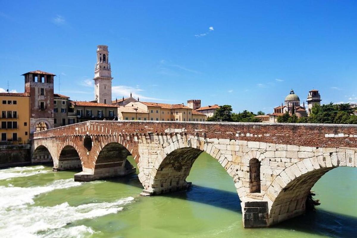 a stone bridge over a river in a city